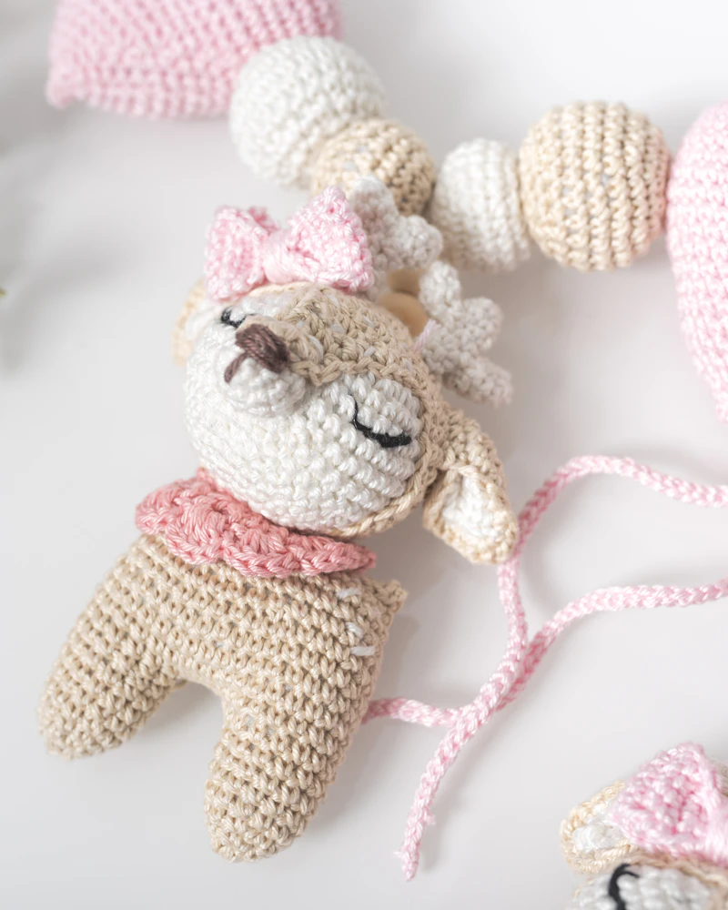 Brown crocheted teddy bear on white surface